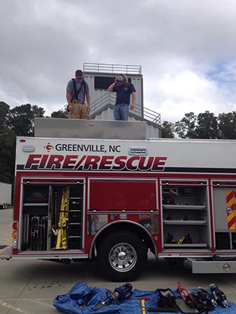 Students standing on top of Greenville Fire\/Rescue truck